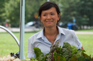 Amy, staff at farm, holding vegetables