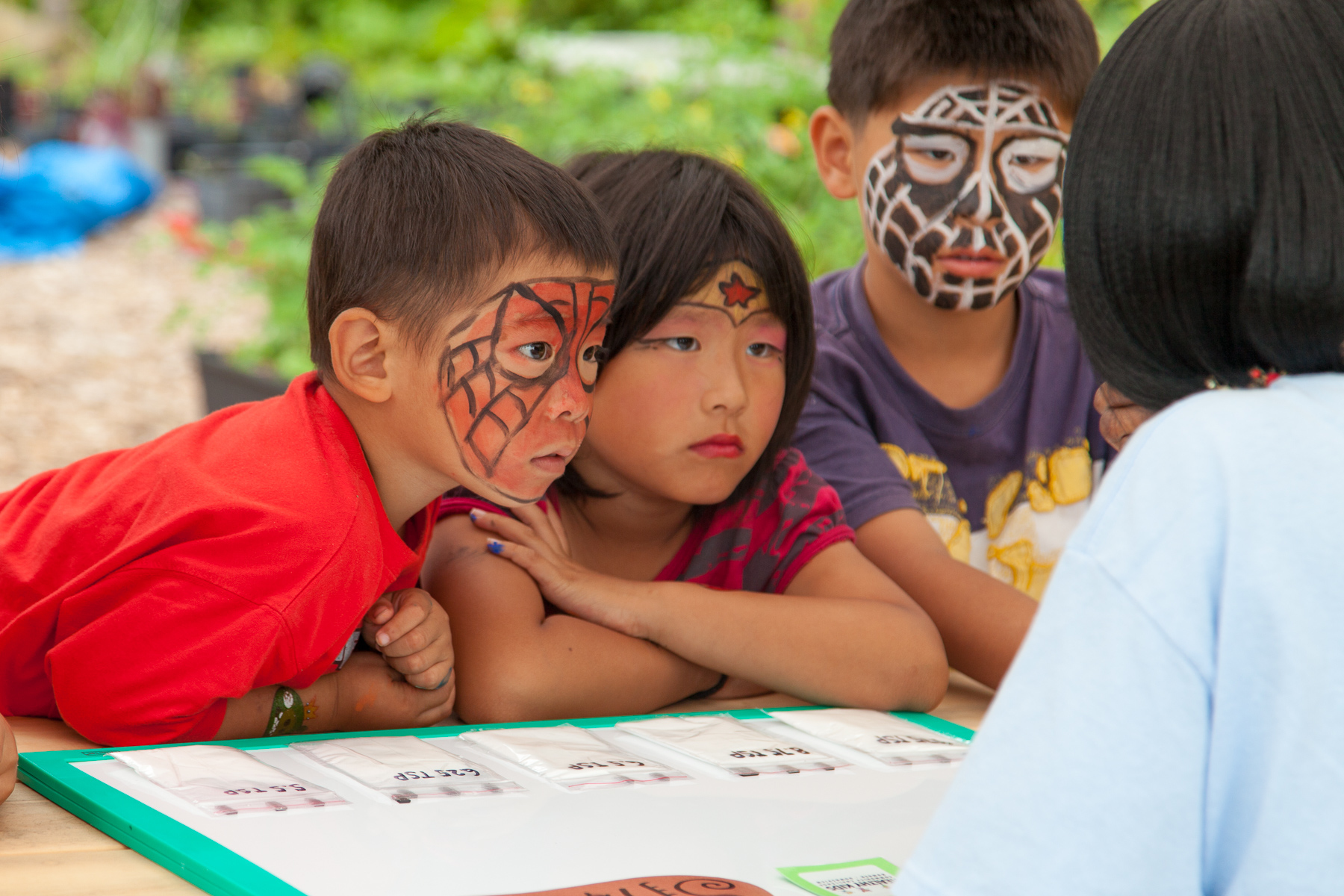 Kids with painted faces take part in an activity at the annual Black Creek Community Farm Festival.