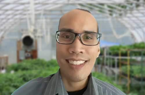 Ezra, smiling inside the greenhouse at BCCF