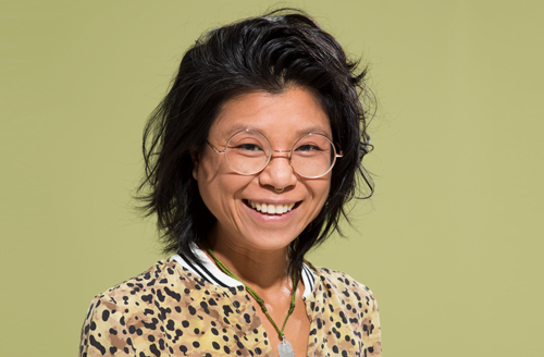 Vanessa Ling Yu smiling - she wears glasses, has dark hair and a leopard print top