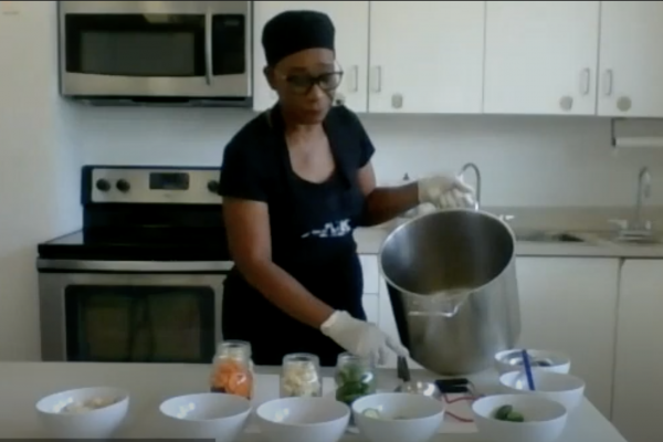 Angela, Urban Harvest Community leader cooking in kitchen