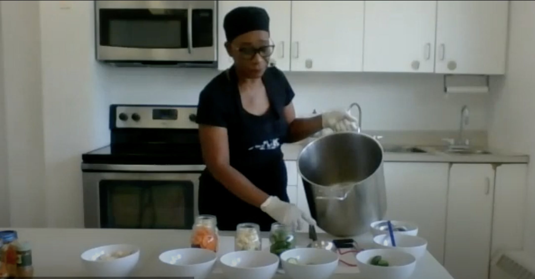 Angela, Urban Harvest Community leader cooking in kitchen